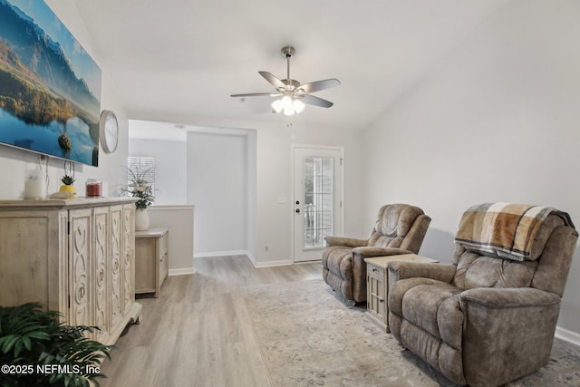 living area with ceiling fan and light wood-type flooring