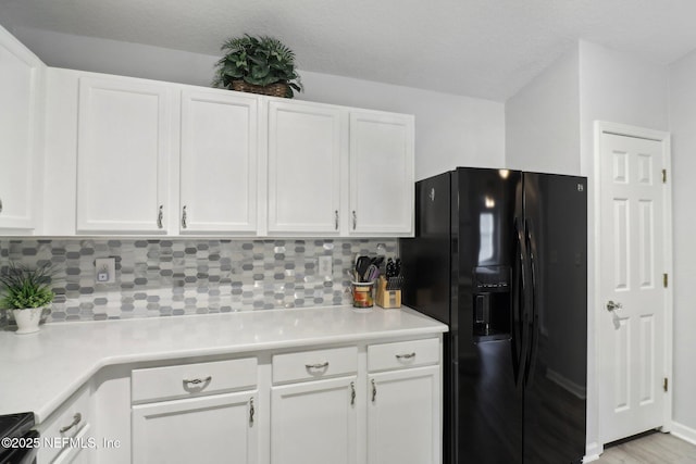 kitchen with white cabinetry and black appliances