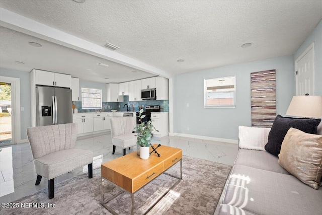 living room with a wealth of natural light and a textured ceiling