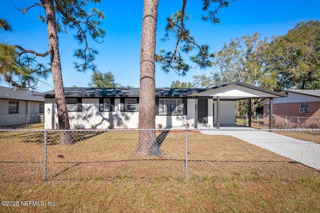 ranch-style home featuring a front yard and a carport