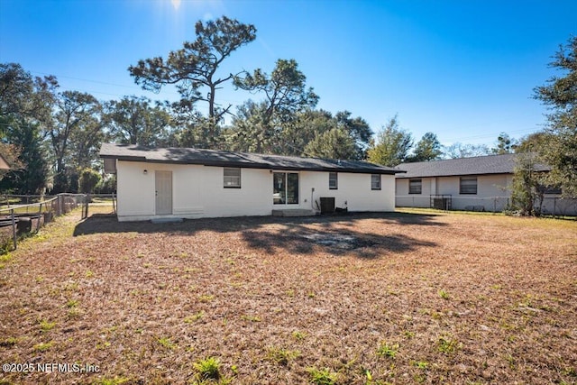 rear view of house featuring a yard