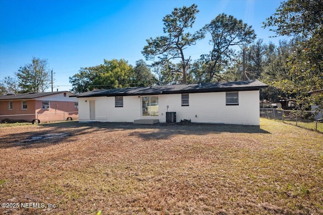 back of house with a lawn and cooling unit