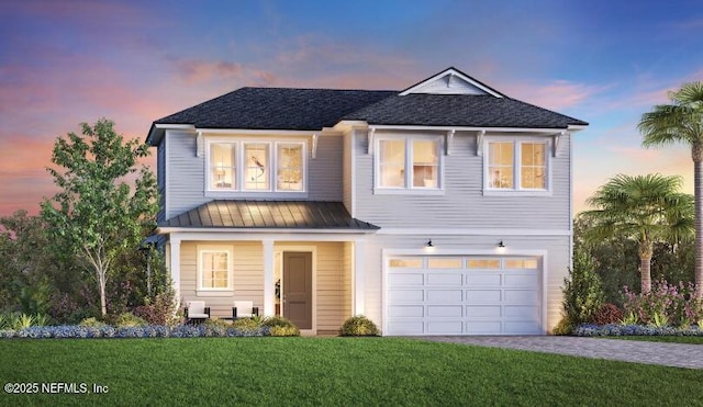 view of front of home with a garage and a lawn