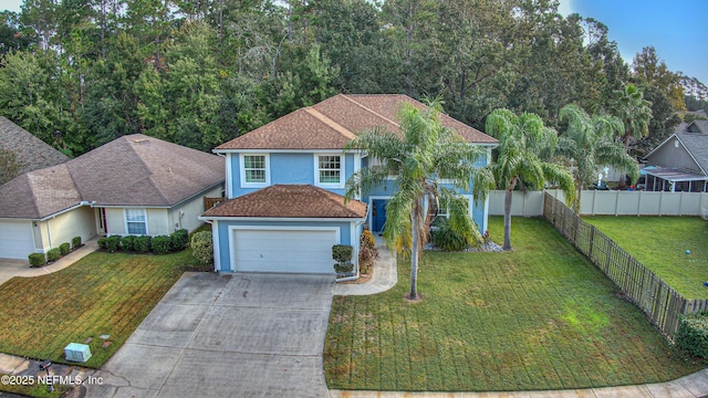 view of front of property featuring a garage and a front lawn