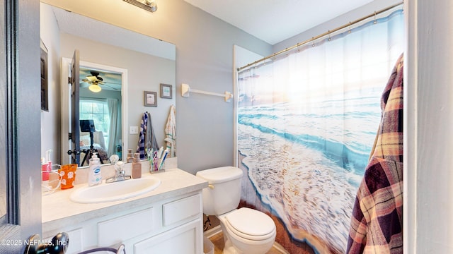 bathroom featuring vanity, toilet, and ceiling fan