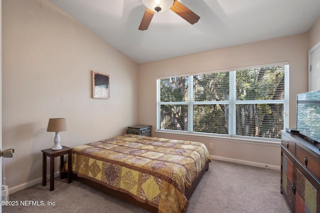 carpeted bedroom with ceiling fan, lofted ceiling, and multiple windows