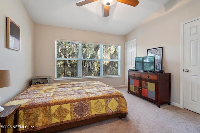 carpeted bedroom with vaulted ceiling and ceiling fan