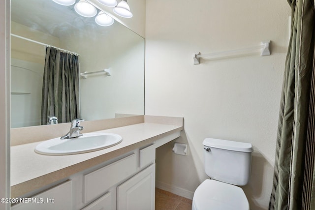 bathroom with tile patterned floors, a shower with curtain, vanity, and toilet