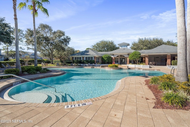 view of swimming pool with a patio area