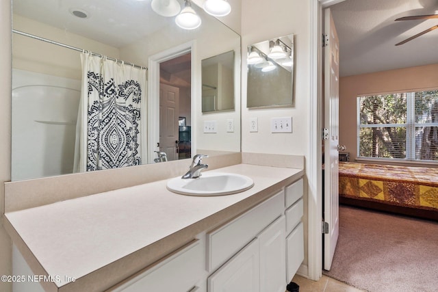 bathroom featuring tile patterned floors, vanity, ceiling fan, and curtained shower