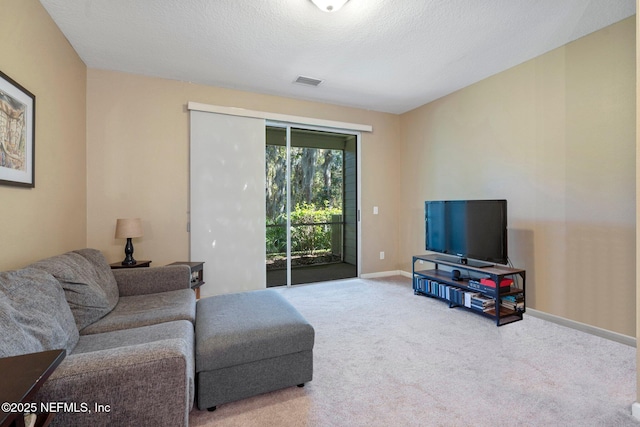 carpeted living room with a textured ceiling