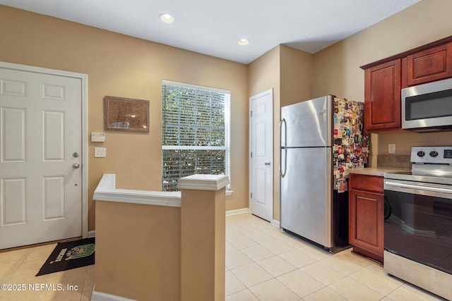 kitchen with light tile patterned floors and stainless steel appliances