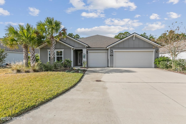 view of front of home with a front yard and a garage