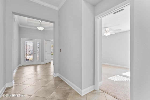 tiled foyer featuring ceiling fan and crown molding