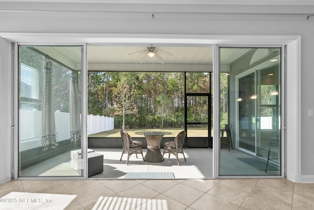 sunroom / solarium with plenty of natural light and ceiling fan