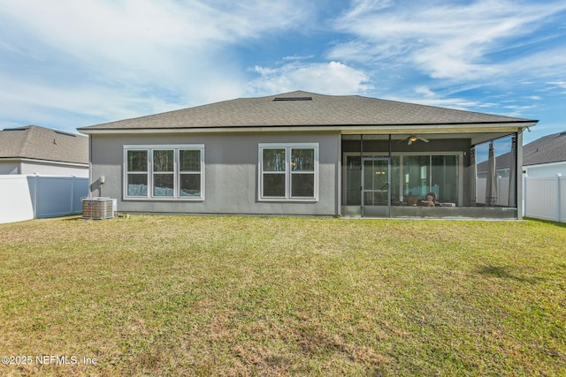 rear view of house featuring a yard, ceiling fan, and a sunroom