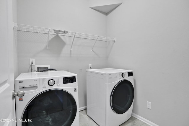 laundry area featuring washing machine and clothes dryer