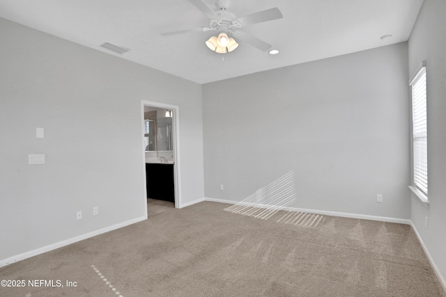 carpeted spare room with ceiling fan and a wealth of natural light