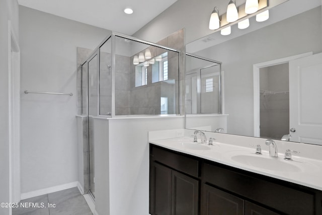 bathroom with tile patterned flooring, vanity, and an enclosed shower