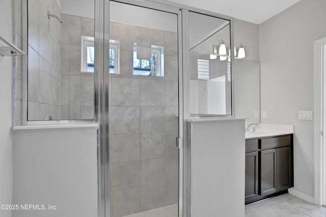 bathroom featuring tile patterned floors, vanity, and a shower with shower door