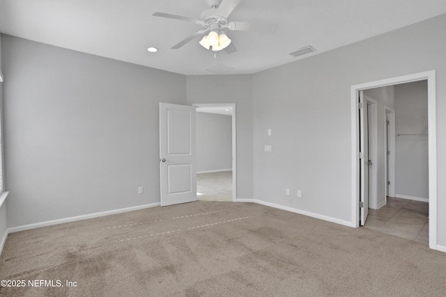 unfurnished bedroom with ceiling fan and light carpet