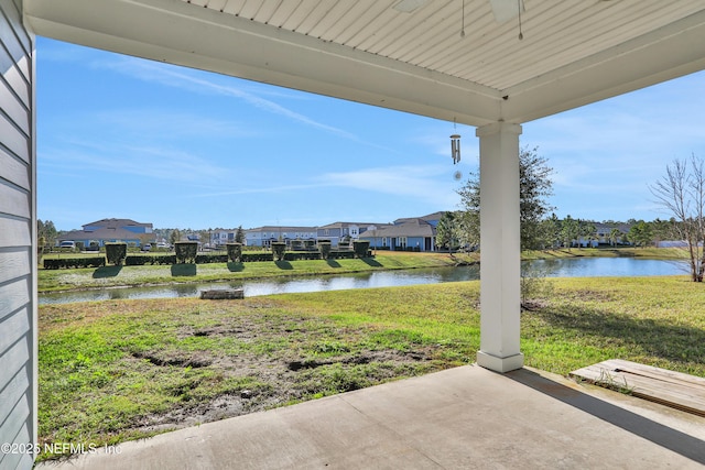 view of yard with a patio area and a water view