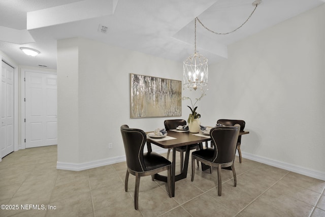 tiled dining room with an inviting chandelier