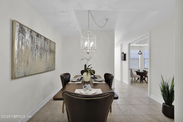 dining area featuring an inviting chandelier and light tile patterned floors