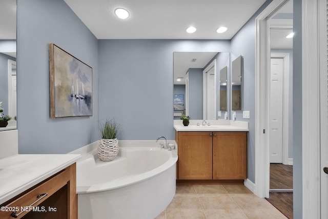 bathroom with vanity, tile patterned floors, and a bathing tub