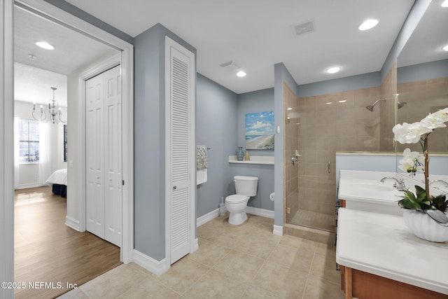 bathroom featuring toilet, walk in shower, tile patterned floors, vanity, and a notable chandelier