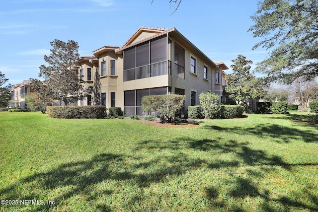 rear view of property with a lawn