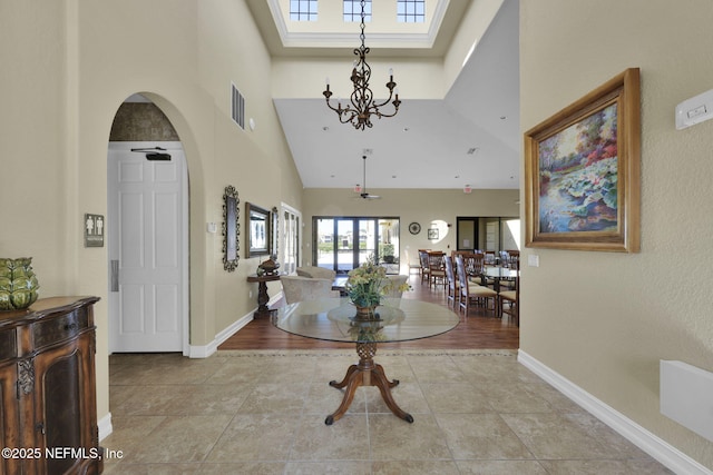 foyer entrance with a high ceiling and ceiling fan