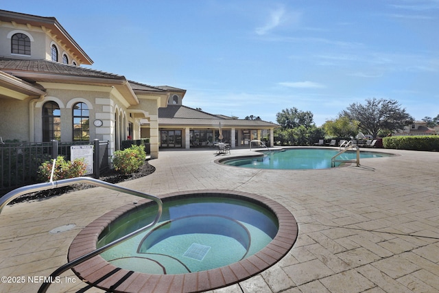 view of pool with a community hot tub and a patio