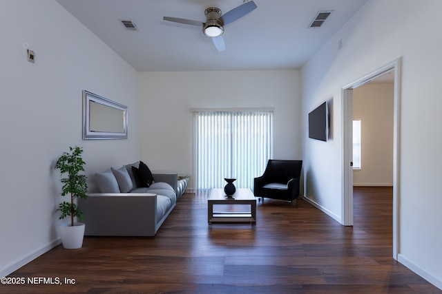 living room with ceiling fan and dark hardwood / wood-style flooring