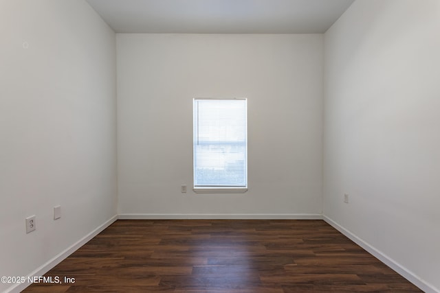 spare room featuring dark hardwood / wood-style floors