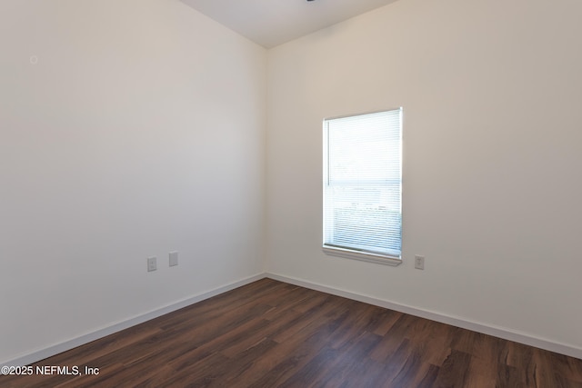 unfurnished room featuring dark wood-type flooring