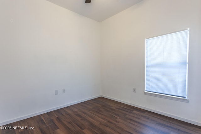 empty room with dark hardwood / wood-style floors and ceiling fan