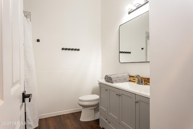 bathroom featuring hardwood / wood-style flooring, vanity, and toilet