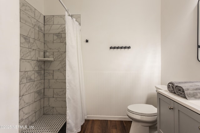 bathroom featuring hardwood / wood-style floors, vanity, curtained shower, and toilet