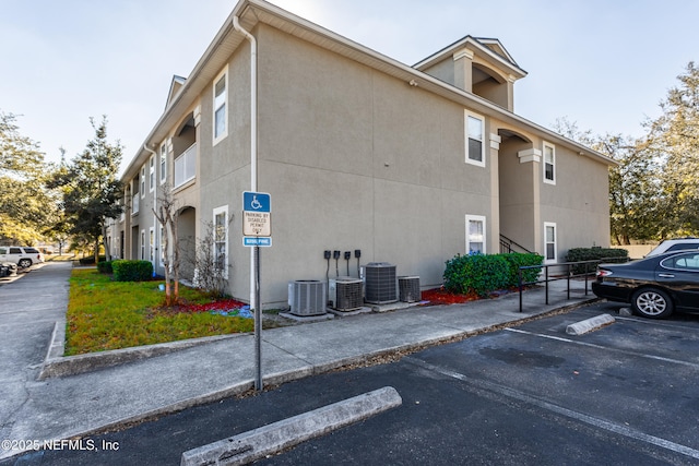 view of side of home with central AC unit