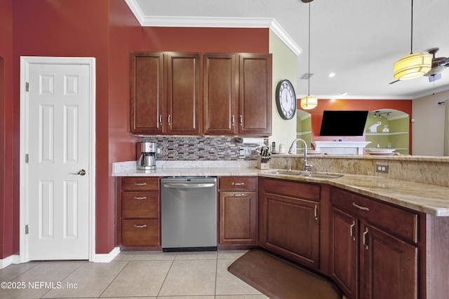 kitchen featuring light stone counters, hanging light fixtures, crown molding, stainless steel dishwasher, and a sink