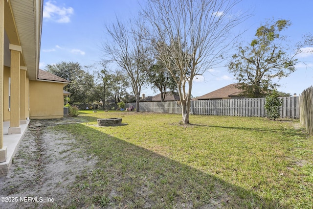 view of yard with an outdoor fire pit and a fenced backyard