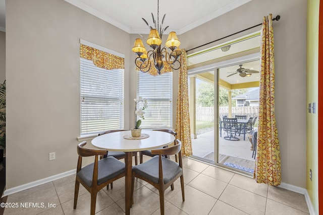 dining space with ceiling fan with notable chandelier, crown molding, baseboards, and light tile patterned floors