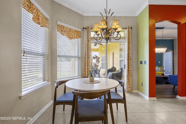 dining space featuring light tile patterned floors, crown molding, arched walkways, and a notable chandelier