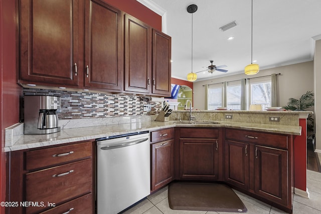 kitchen with light stone counters, pendant lighting, stainless steel dishwasher, a sink, and a peninsula