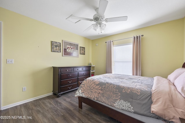 bedroom with baseboards, dark wood finished floors, and a ceiling fan