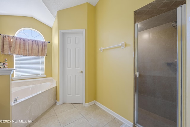 bathroom with lofted ceiling, tile patterned flooring, a garden tub, baseboards, and a stall shower