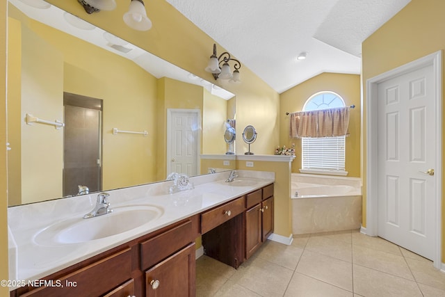 full bathroom with lofted ceiling, tile patterned flooring, a garden tub, and a sink