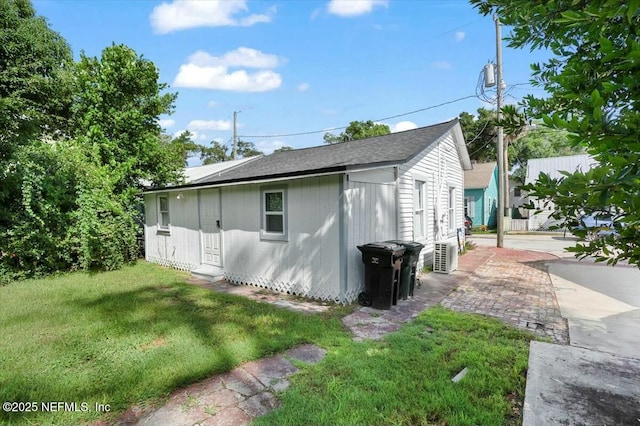 view of side of home with a yard