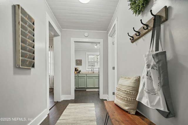 mudroom with dark hardwood / wood-style flooring, wooden ceiling, and sink